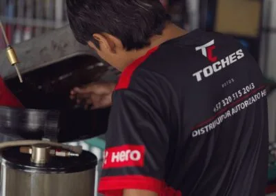 Mecánico de Toches Motos revisando el aceite del motor